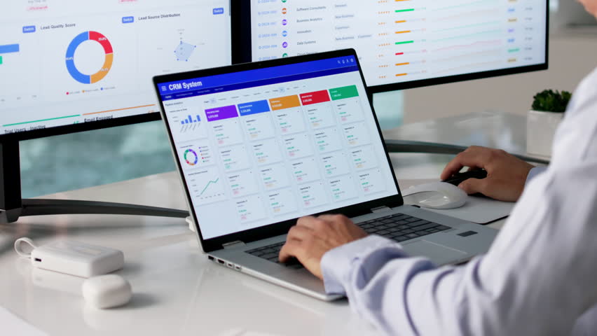 Sales Manager Reviewing Customer Data On Computer To Improve Business Growth.