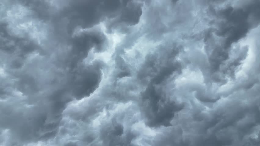 Black and gray clouds cover the sky. Clouds are approaching before a storm and rain with a thunderstorm