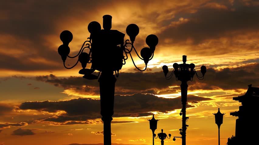 Street lamp on Tiananmen Square in Beijing, China (against the sunset), with propaganda or public announcement speakers. 4K, time lapse, with zoom 