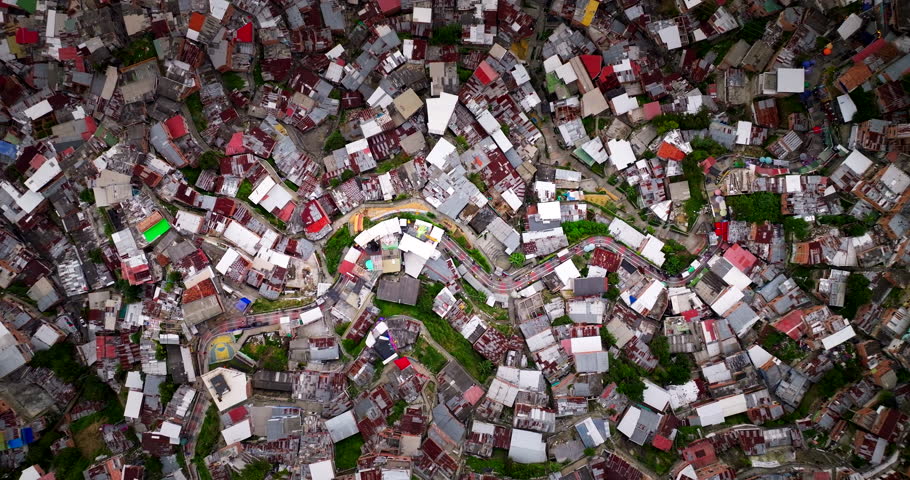 Dense hillside housing and narrow winding streets in Medellín, Colombia on April 4, 2025 showing compact urban development, top-down aerial view