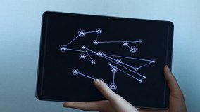 Person interacts with a tablet displaying a network of connected nodes on a white background during a technology demonstration. - Powered by Shutterstock - Get 15% off with code: PIKWIZARD15