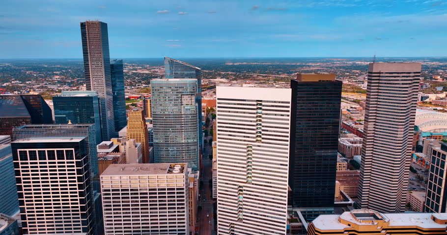 Skyscrapers in the financial center of Houston, Texas, USA. Low-rise green cityscape at backdrop. Aerial view.