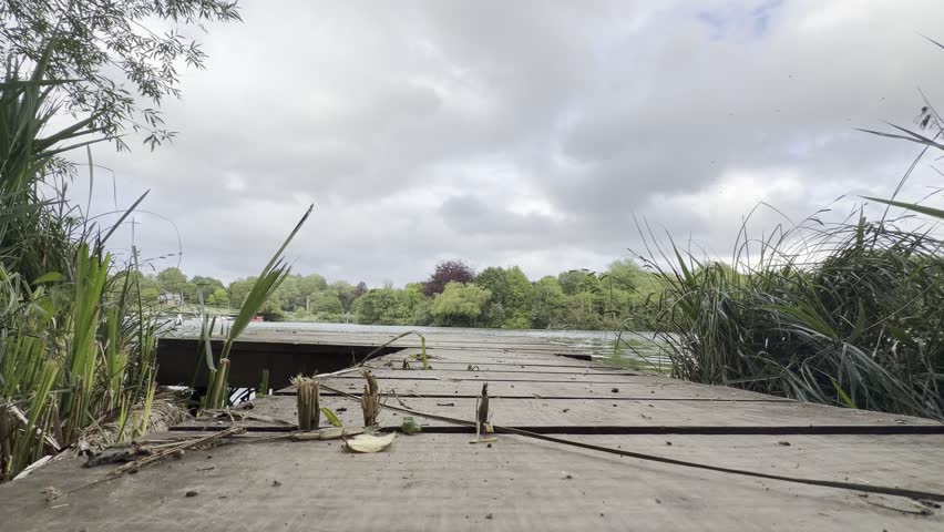 Old wooden dock overlooking tranquil lake detail