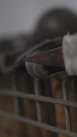 Close-up view of various hammers hanging on a metal rack in a workshop or hardware store