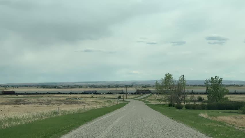 Driving Down a Gravel Road in Rural Countryside Landscape