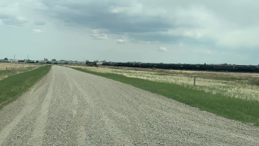 Driving Down a Gravel Road in Rural Countryside Landscape