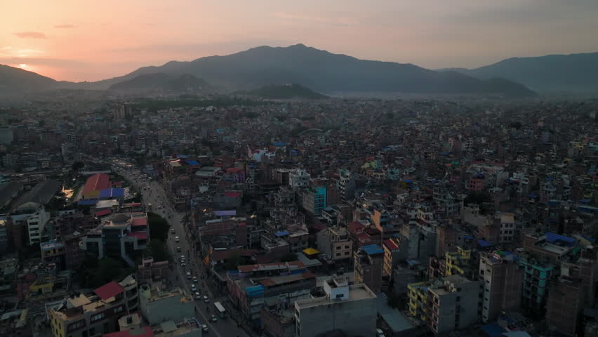 Expansive aerial view of Kathmandu cityscape in Nepal with morning haze over the mountains