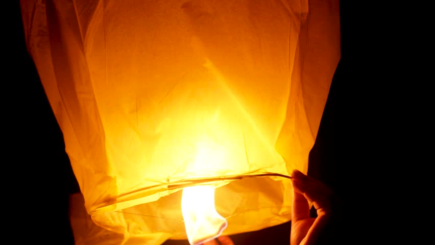 Family members releasing a bright Sky Lantern in the sky together, religious celebration of happy Diwali, Fanush in sky, Diwali celebration concept background videos.