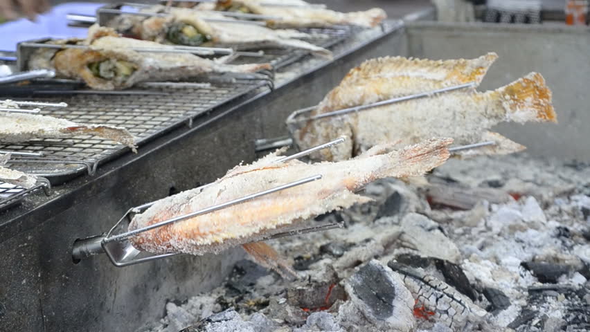 roast fish mix with salt on stove machine