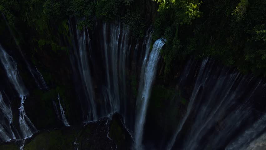 Stunning 4K aerial view of Tumpak Sewu waterfall curtains in East Java, Indonesia.