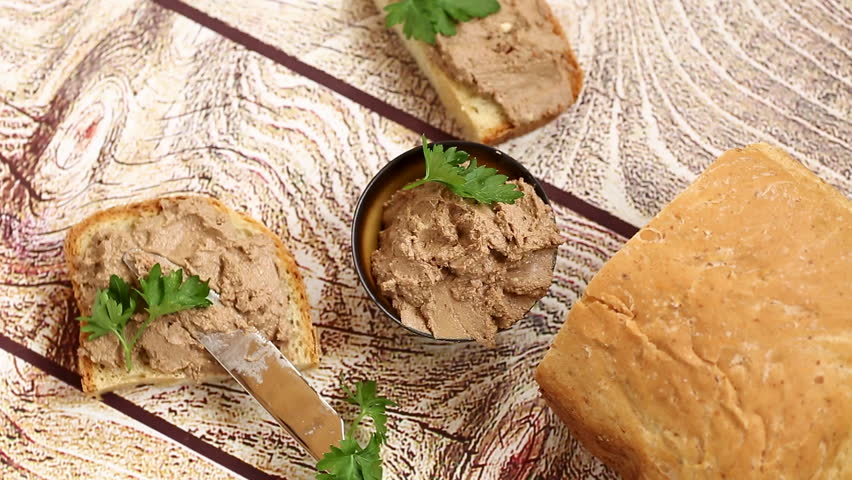 Rustic appetizer with liver pate and parsley garnish