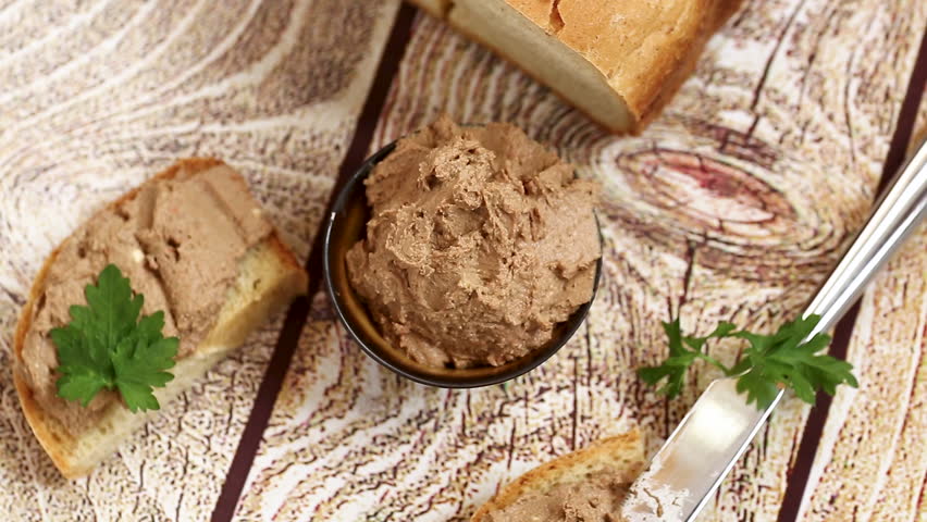 Rustic appetizer with liver pate and parsley garnish