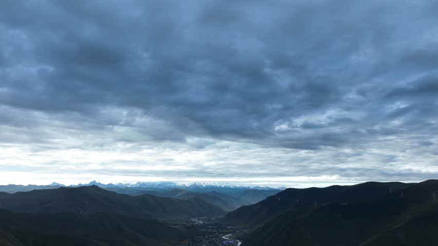 Aerial footage landscape of foggy snow capped mountains in sichuan, China