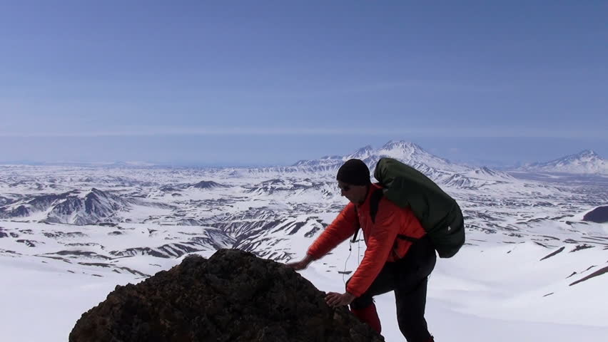 Rock climber on the top of mountain. 