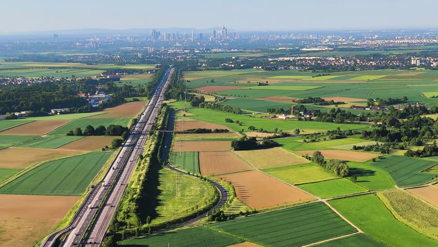 A landscape from a drone perspective, with a view of the motorway leading to Frankfurt am Main.. An agricultural landscape from the air.