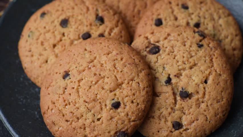 Food, oatmeal chocolate raisin cookies, dessert or breakfast pastry. Oatmeal chocolate cookies as a food background for your design