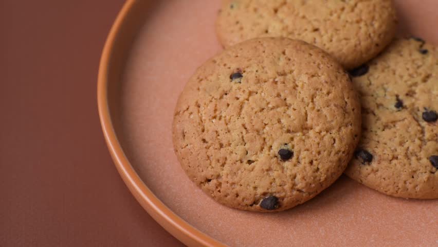 Food, oatmeal chocolate raisin cookies, dessert or breakfast pastry. Oatmeal chocolate cookies as a food background for your design