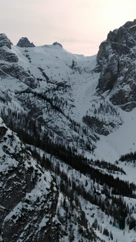 Serene Dusk In Jagged Mountain Landscape. Peaceful Evening With Snowcapped Basin And Shaded Ridges. Media