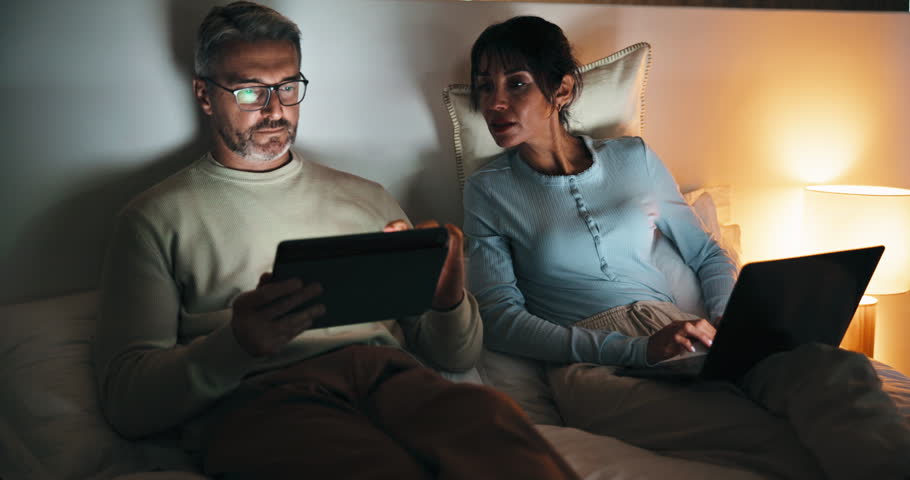 Night, remote work and couple with tech in bedroom, creative and plan for ebook chapter with tablet. Happy, writer and mature people with laptop for story development, home and novel deadline on web