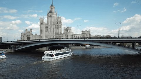 Drone Flying Behind Cruise Ship on River