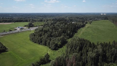 Smooth Forward Aerial over Highway beside Forest