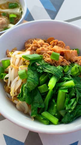 Chicken noodle with meatball and dumpling.