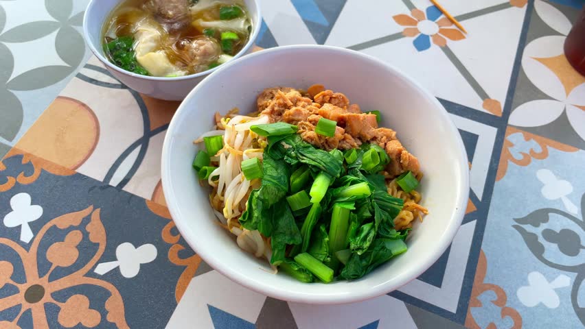 Chicken noodle with meatball and dumpling.