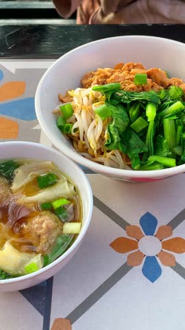 Chicken noodle with meatball and dumpling.