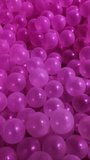 Top down view of multiple translucent plastic balls in a playground ball pit illuminated by vibrant changing LED lights, creating a magical and colorful glowing abstract background. - Powered by Shutterstock - Get 15% off with code: PIKWIZARD15