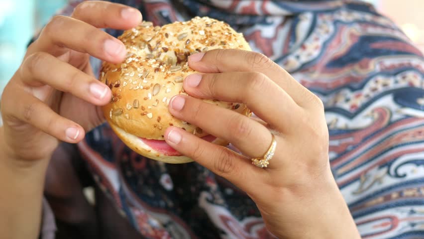 Savoring a sesame bagel with cream cheese and jelly