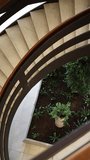 Vertical screen Spiral staircase with indoor garden and modern architectural design inside luxury business or cultural center with natural decorative plants - Powered by Shutterstock - Get 15% off with code: PIKWIZARD15