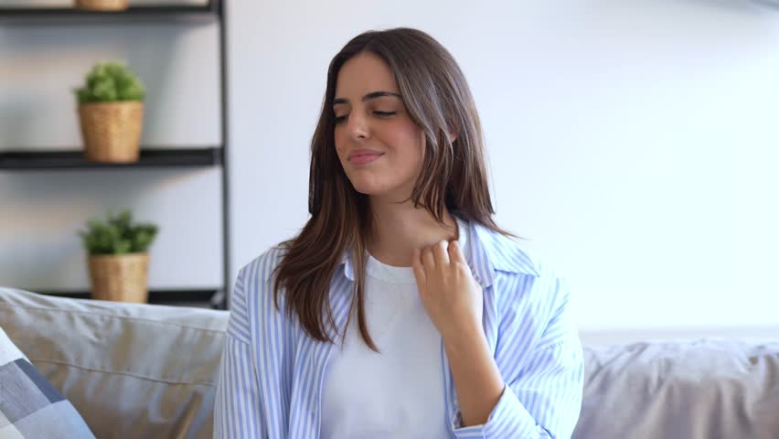 Young Woman Finds Relief for Neck Pain and Shoulder Discomfort While Relaxing at Home