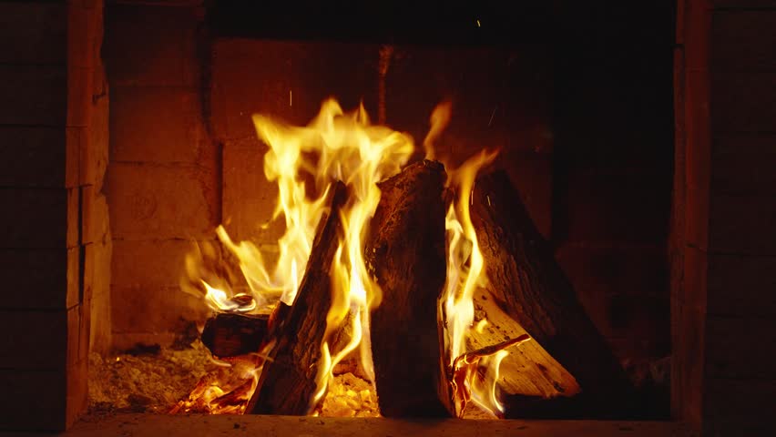 Wood burning in a cozy fireplace at home 4k footage