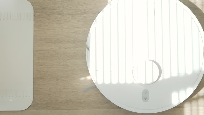 Robotic vacuum cleaner mopping wooden floor with sunlight, smart home appliance using automation for modern lifestyle.