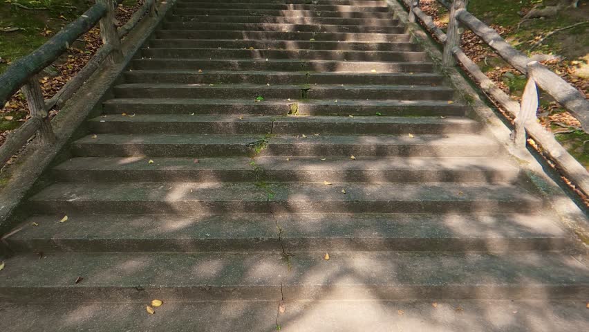 Low angle shot of looking up a wide stone staircase slowly