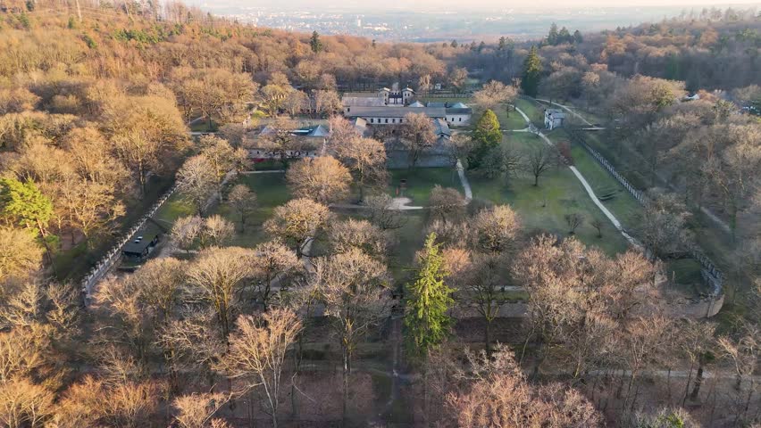 Top-down drone image of reconstructed stone buildings, courtyards, paths, and walls at Saalburg Roman Fort in Hesse, Germany.