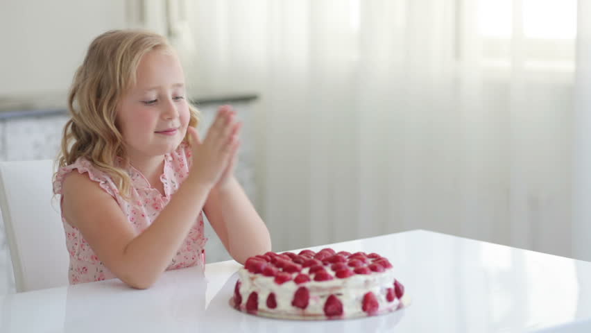 Cute girl going to eat a strawberry cake
