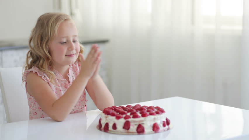 Cute girl going to eat a strawberry cake
