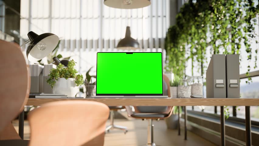 Laptop blank green screen mockup in a bright modern office space with greenery and natural light, close-up front view. Luma matte and trackin clip included. 3d render
