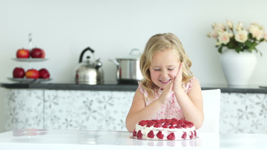 Girl eating strawberry of cake
