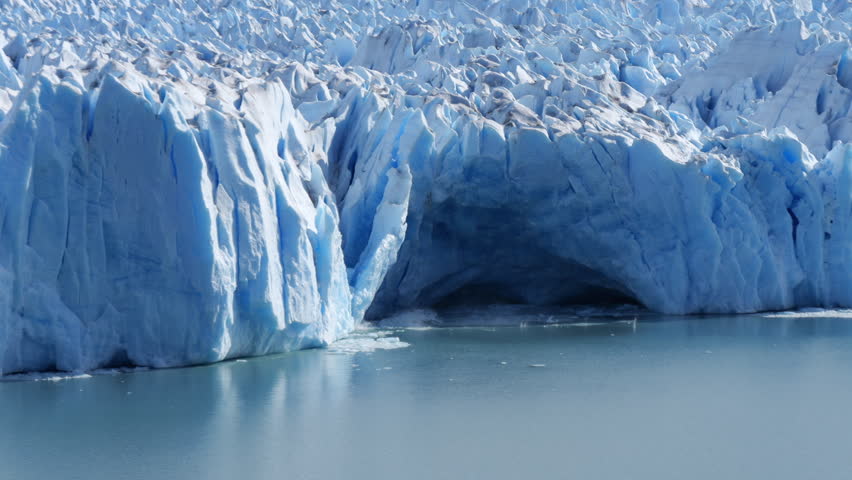 Ice collapsing from Perito Moreno Glacier into icy water in Patagonia.