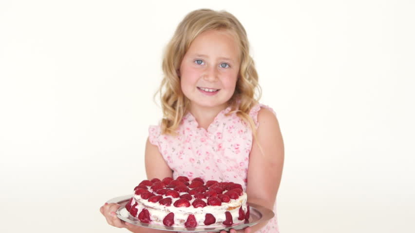 Cute girl holding large cake and smiling

