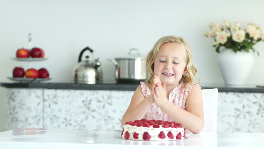 Girl getting ready to eat strawberry cake
