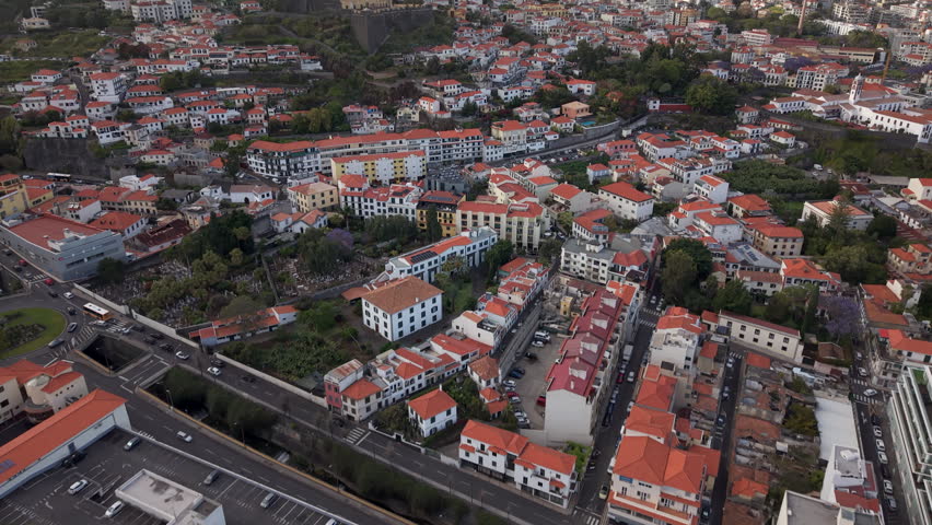 Aerial tilt up shot of Funchal cityscape in Madeira Island, Portugal. 