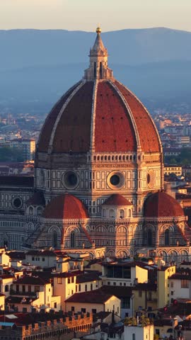 vertical video, orbiting drone shot of Florence old town with the setting sun, Italy, Florence Renaissance cathedral Santa Maria del Fiore at sunset aerial video, travel in Tuscany, Italy. 