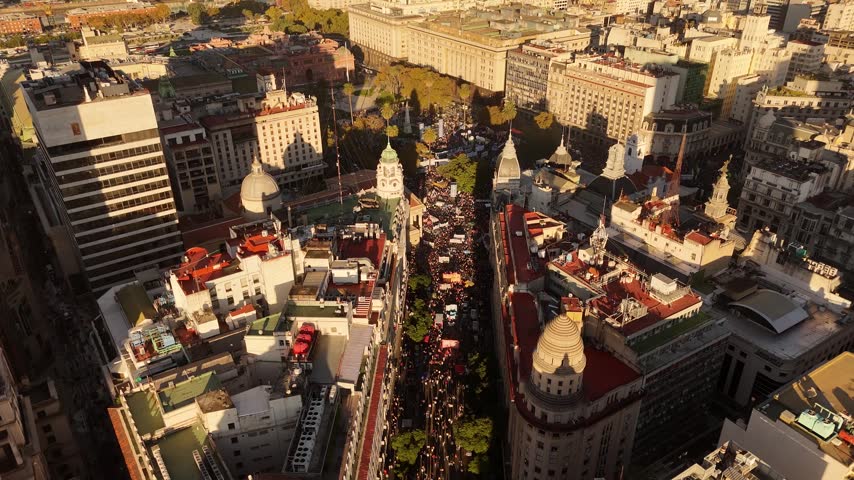 Cinematic sunset view of people filling the streets of Buenos Aires during the massive May 12, 2026 student strike. High-quality 4K clip capturing the historic public education demonstration