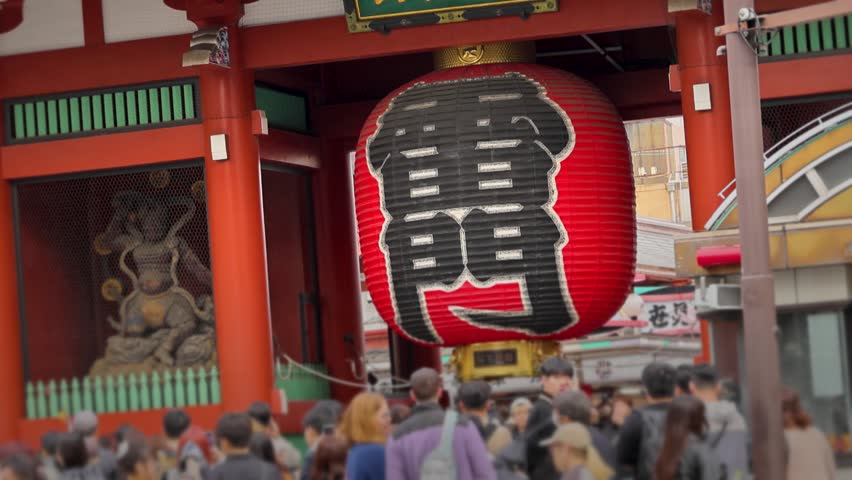 People Walking Beneath Kaminarimon Lantern at Sensoji Tokyo Japan