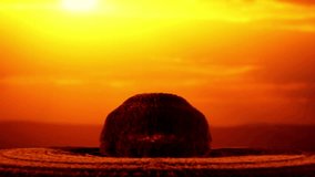 Cinematic 4k shot of a massive nuclear explosion with a mushroom cloud rising against a dramatic orange sunset horizon. High-impact visual for war, history, and apocalyptic themes. - Powered by Shutterstock - Get 15% off with code: PIKWIZARD15