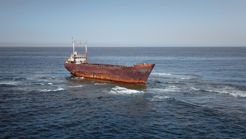 Rusty cargo ship Edro III shipwrecked off the coast of Peyia, Paphos, Cyprus, standing aground in the Mediterranean Sea, offering striking view of maritime history and decay. Aerial view drone flight