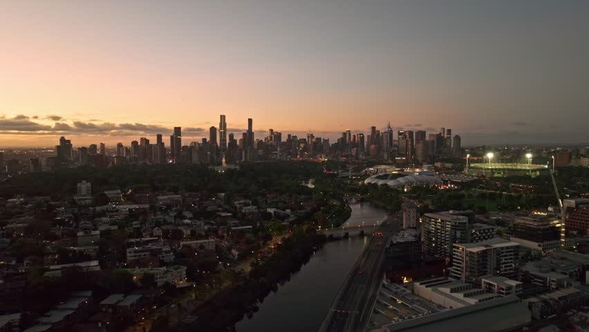 Aerial view of the Yarra River and Melbourne city skyline at sunset in South Yarra, Victoria, Australia.